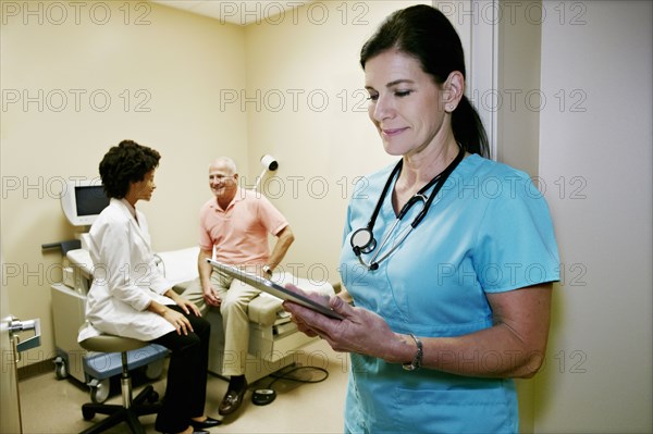 Caucasian nurse using digital tablet