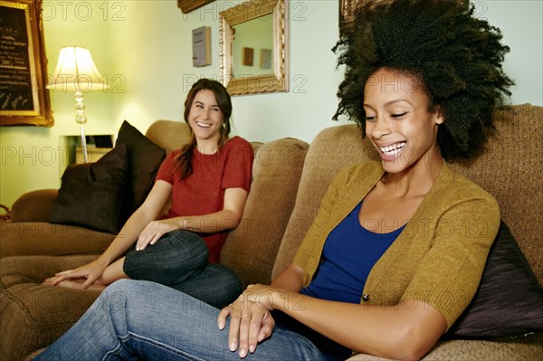 Women relaxing on sofa