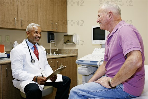 Doctor talking to patient in office