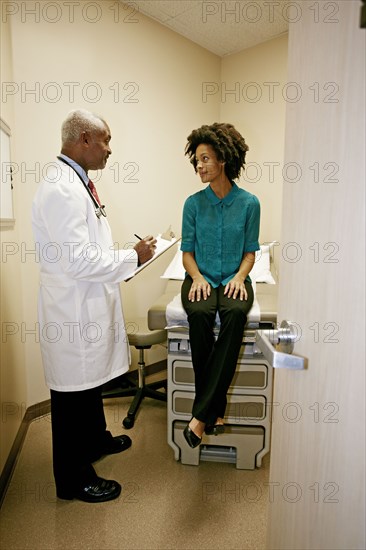 Doctor talking to patient in office