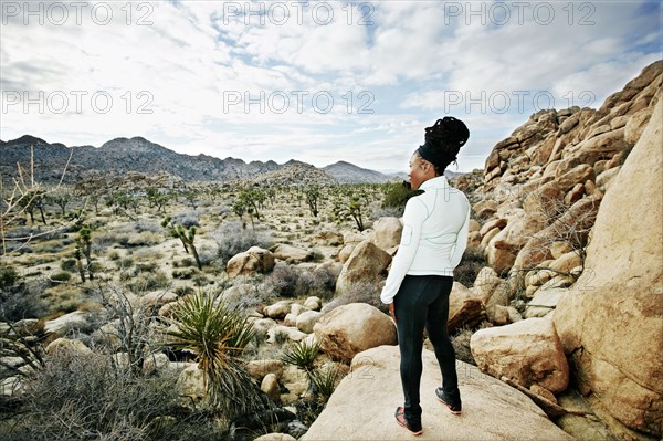 Black runner in desert landscape