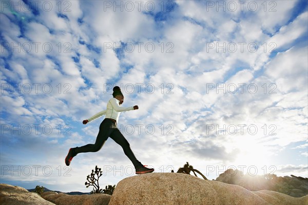 Black runner in desert landscape