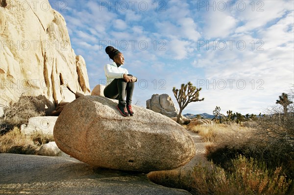 Black runner in desert landscape