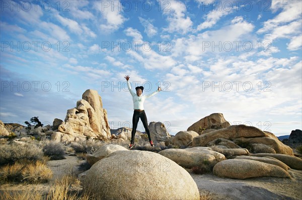 Black runner in desert landscape