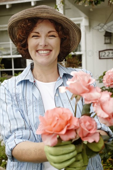 Smiling woman working in garden