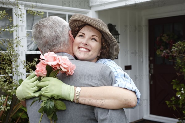 Woman hugging husband in garden