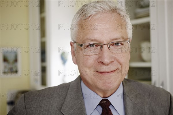 Businessman smiling in kitchen