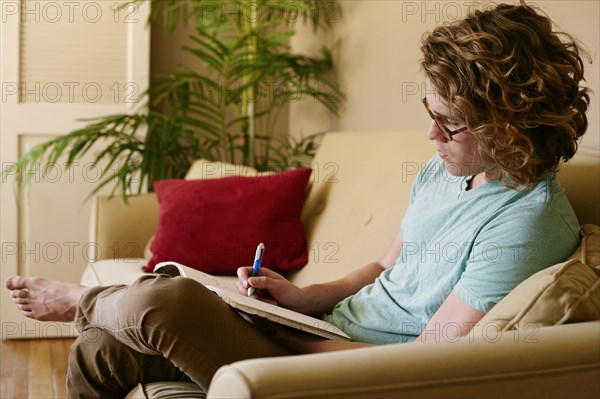 Caucasian man drawing on sofa