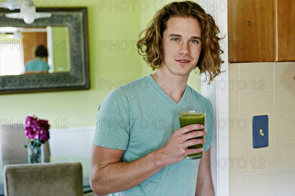 Caucasian man having glass of juice