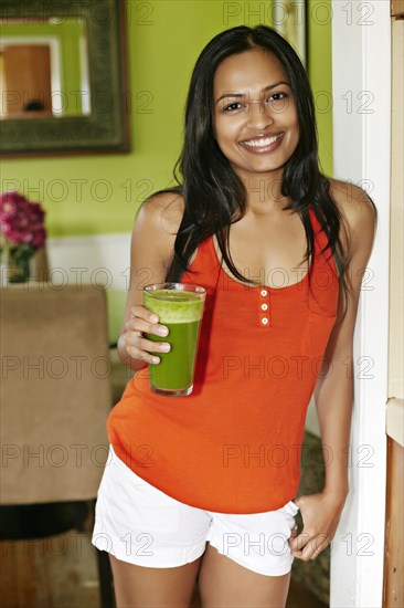 Indian woman having glass of juice