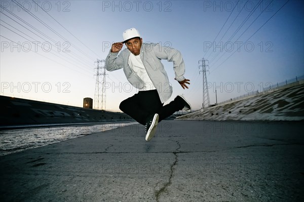 Hispanic man dancing on urban street