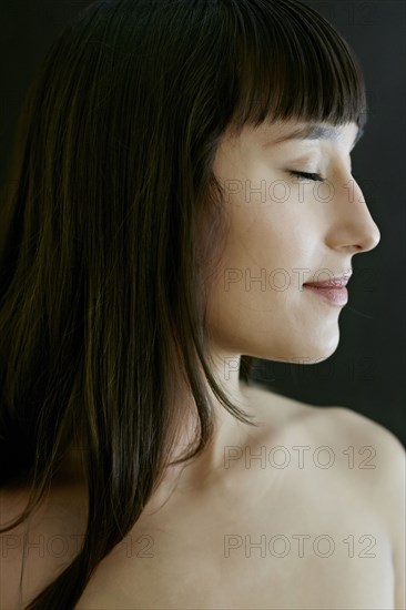 Nude mixed race woman smiling