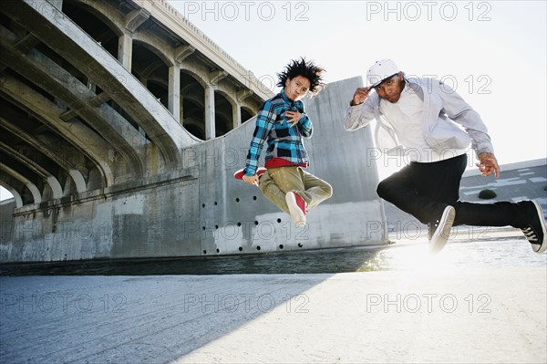 Men break dancing under overpass