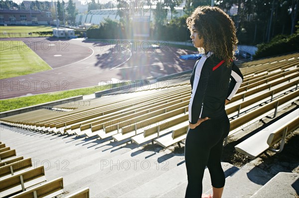 Mixed race runner training in stadium