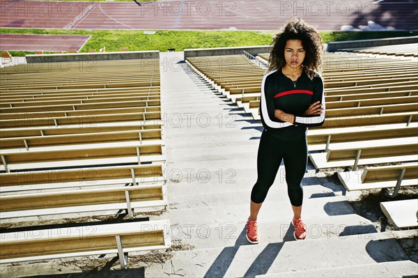 Mixed race runner training in stadium