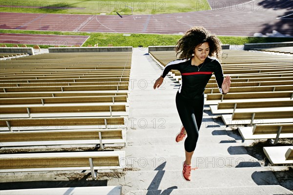 Mixed race runner training in stadium