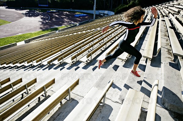 Mixed race runner training in stadium