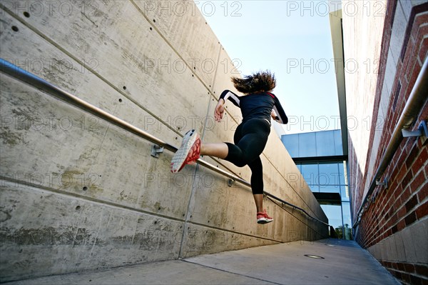 Mixed race runner training in stadium