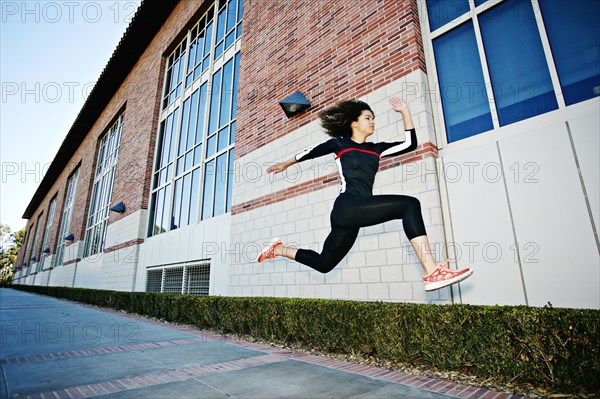 Mixed race woman running on city street