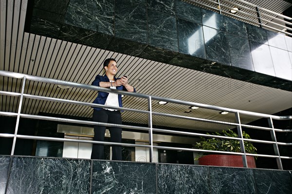 Hispanic businesswoman using cell phone