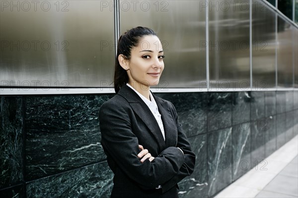 Mixed race businesswoman standing outdoors
