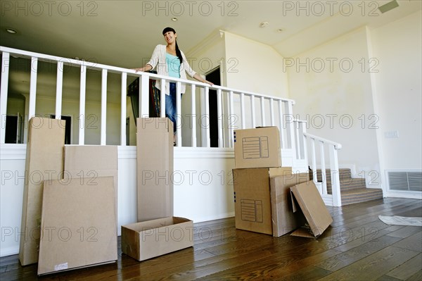 Mixed race woman smiling in new home