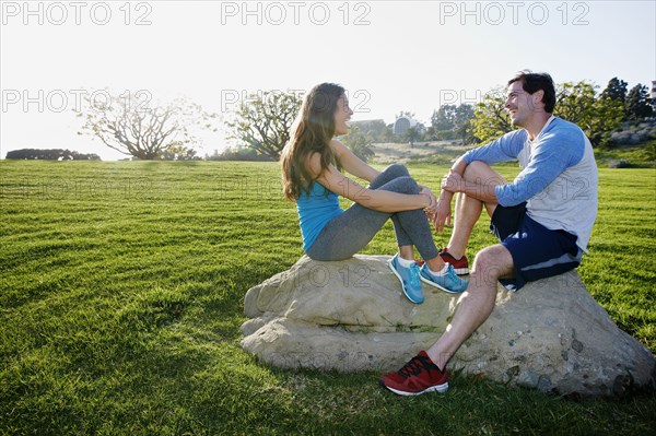 Couple wearing workout gear in park