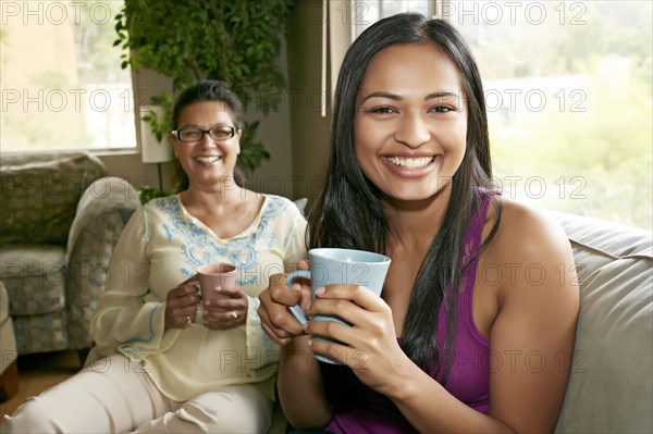 Mother and daughter having coffee together