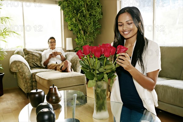 Woman arranging flowers in vase