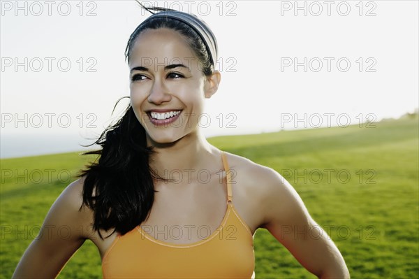 Hispanic woman smiling in field