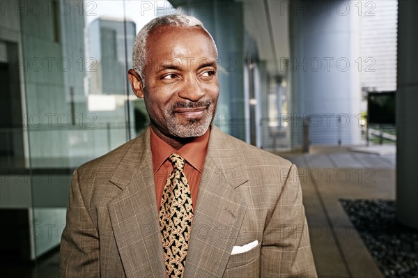 Black businessman smiling outside office