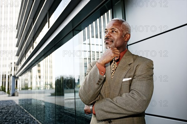 Black businessman smiling outside office