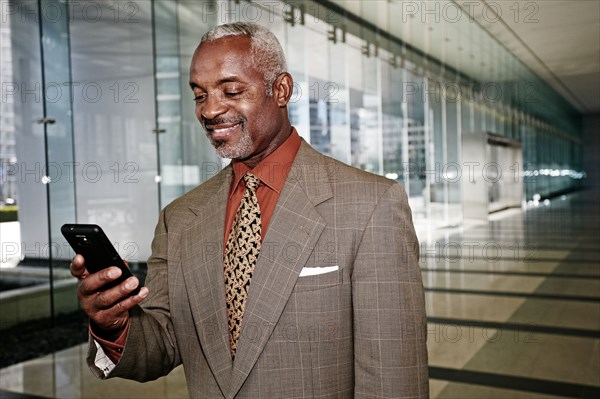 Black businessman using cell phone