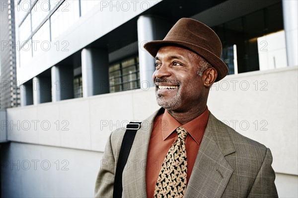 Black businessman standing on city street