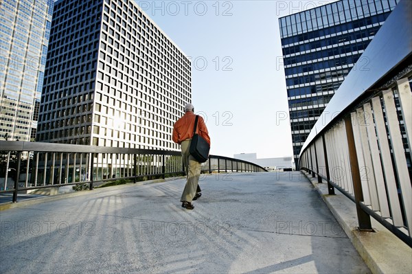 Black businessman walking on urban walkway