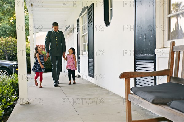 Soldier father with daughters on patio