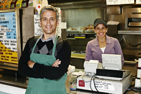 Hispanic servers smiling in restaurant