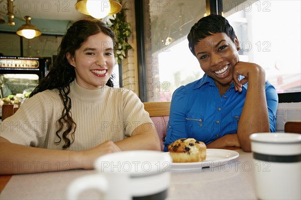 Women laughing in restaurant booth