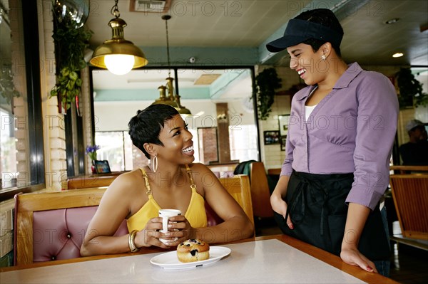Waitress talking to customer in restaurant
