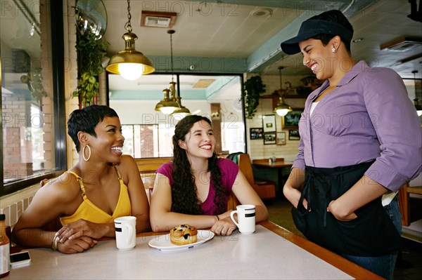 Waitress talking to customers in restaurant