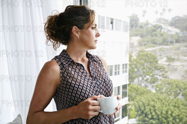 Caucasian businesswoman having cup of coffee