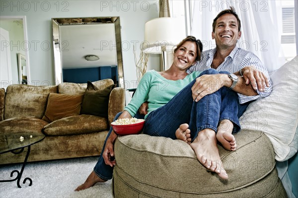 Caucasian couple relaxing in livingroom