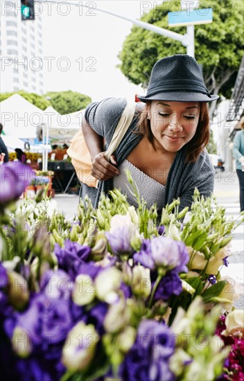 Black woman looking at flowers