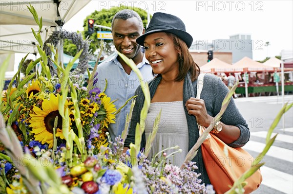 Black couple shopping at outdoor market