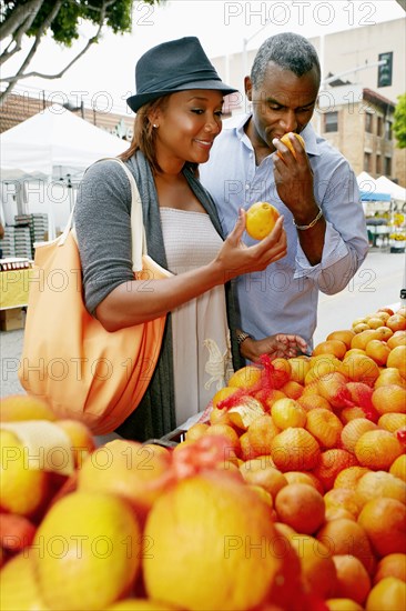 Black couple shopping at outdoor market