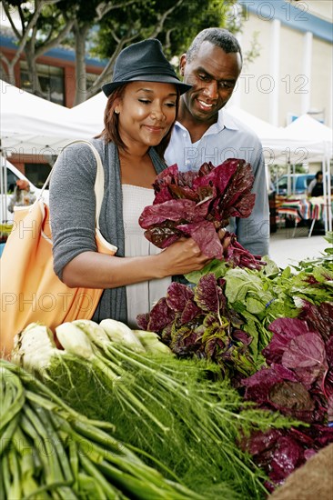 Black couple shopping at outdoor market