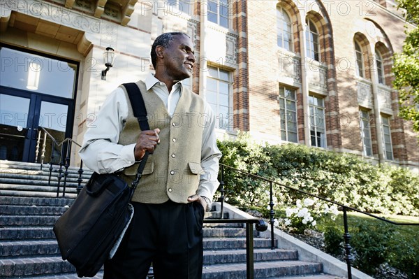 African American professor walking on campus