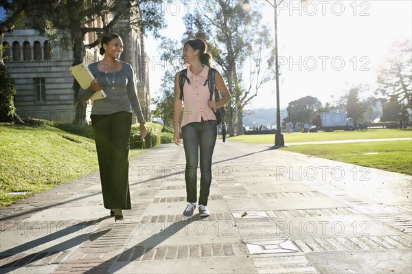 Professor and student walking on campus