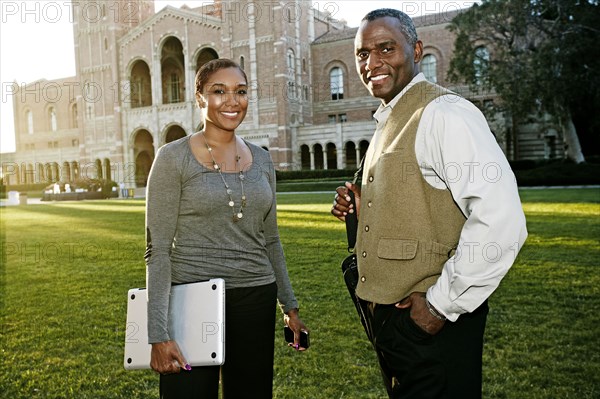 African American professors talking on campus