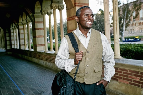 African American professor smiling on campus